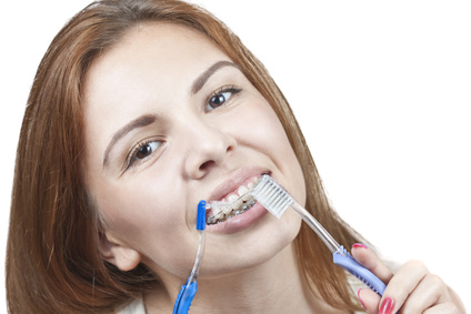 Young girl cleaning her braces