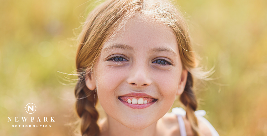 girl smiling with crooked teeth