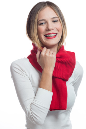 woman in red scarf smiling with braces