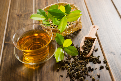 tea and tea leaves on wooden table
